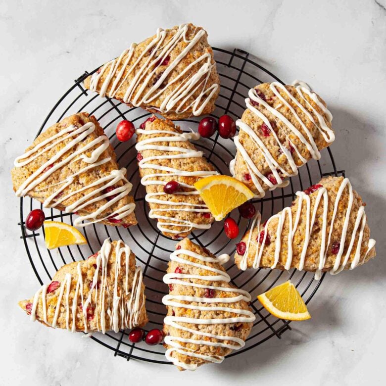 Cranberry orange scones drizzled with melted white chocolate.