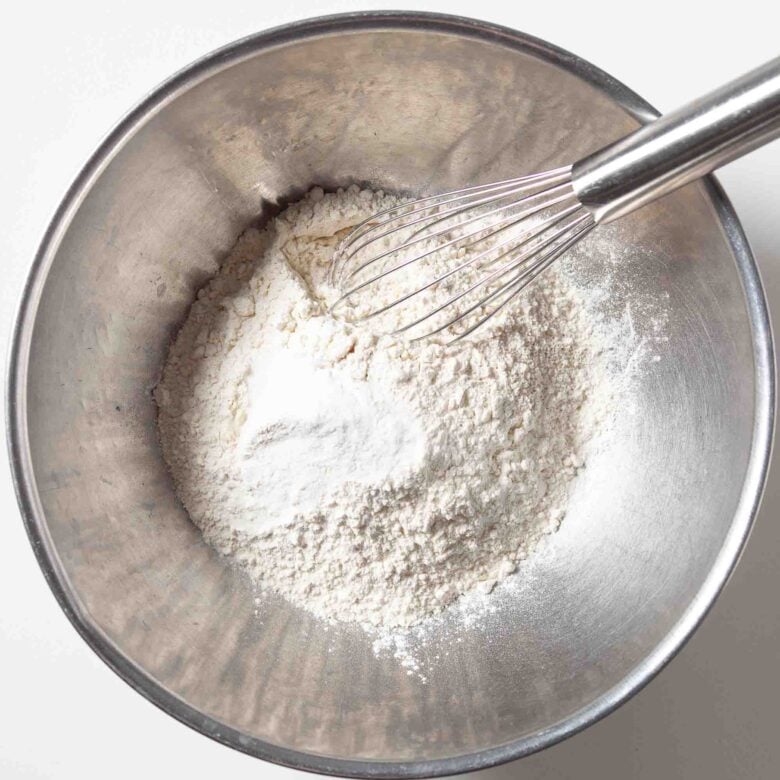 Dry ingredients for m&m cookie bars in a bowl.