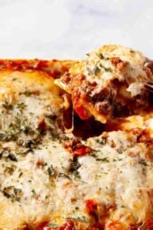 Ravioli Casserole in a pan that's baked with a ladle showing.