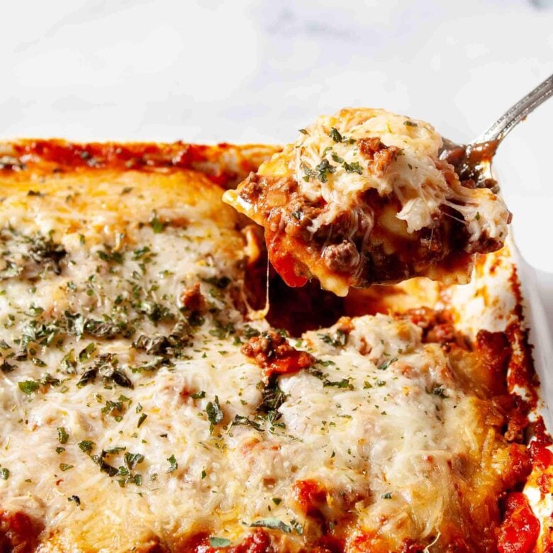 Ravioli Casserole in a pan that's baked with a ladle showing.