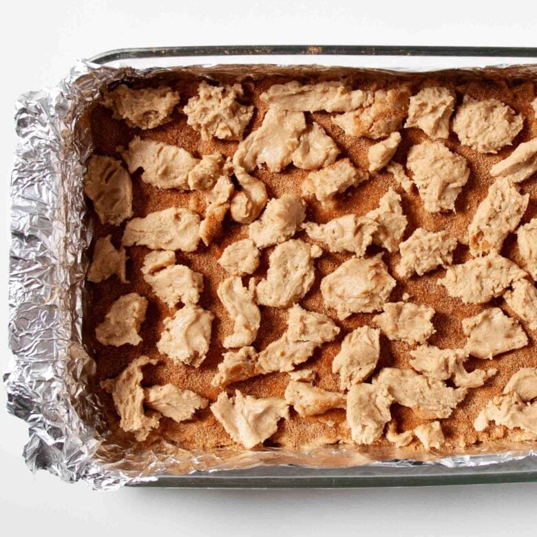 Snickerdoodle bar batter with cinnamon sugar layer, ready to be baked.