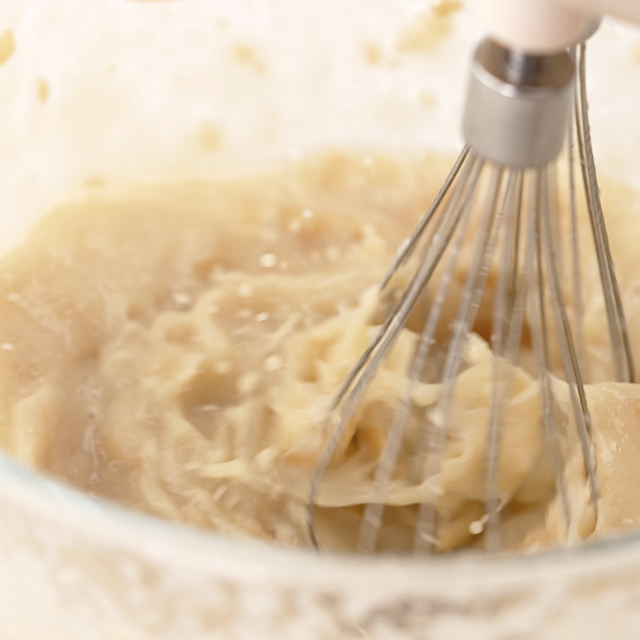 Wet ingredients to make apple oatmeal bars being whisked together.