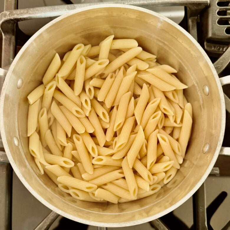 Pasta boiled in a pot to make buffalo chicken pasta.
