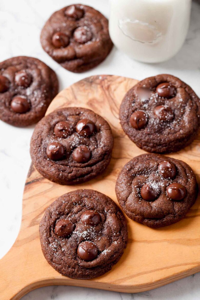 Overhead shot of double chocolate cookies with milk on the side.