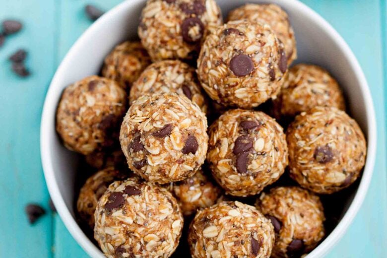 Overhead shot of a bowl with peanut butter energy balls with visible chocolate chips.
