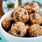 Closeup shot of a bowl with peanut butter energy balls with visible chocolate chips.