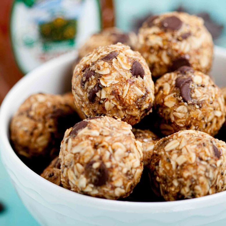 Closeup shot of a bowl with peanut butter energy balls with visible chocolate chips.
