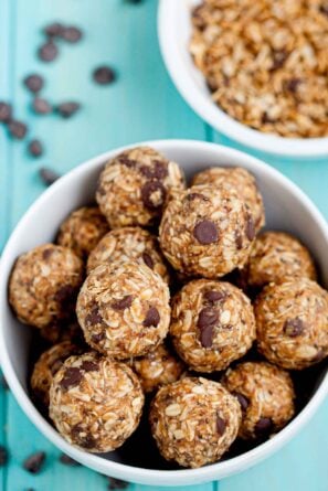 Overhead shot of a bowl with peanut butter energy balls with visible chocolate chips.