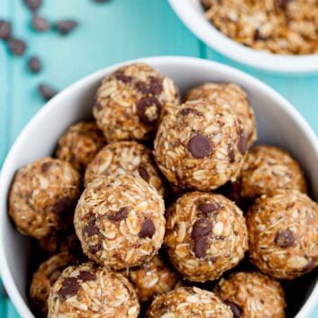 Overhead shot of a bowl with peanut butter energy balls with visible chocolate chips.