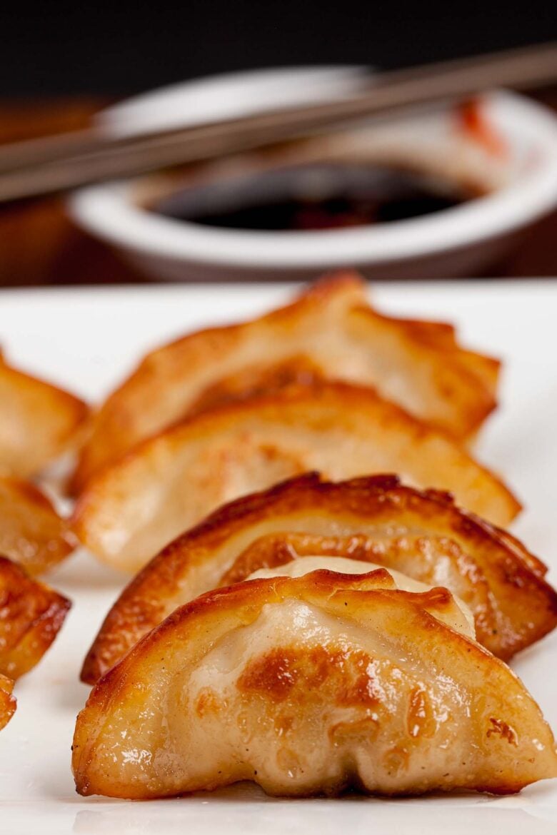 Closeup shot of potsticker on a white plate.