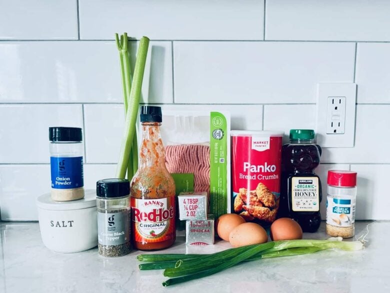 Ingredients to make buffalo chicken meatballs on a white kitchen counter.
