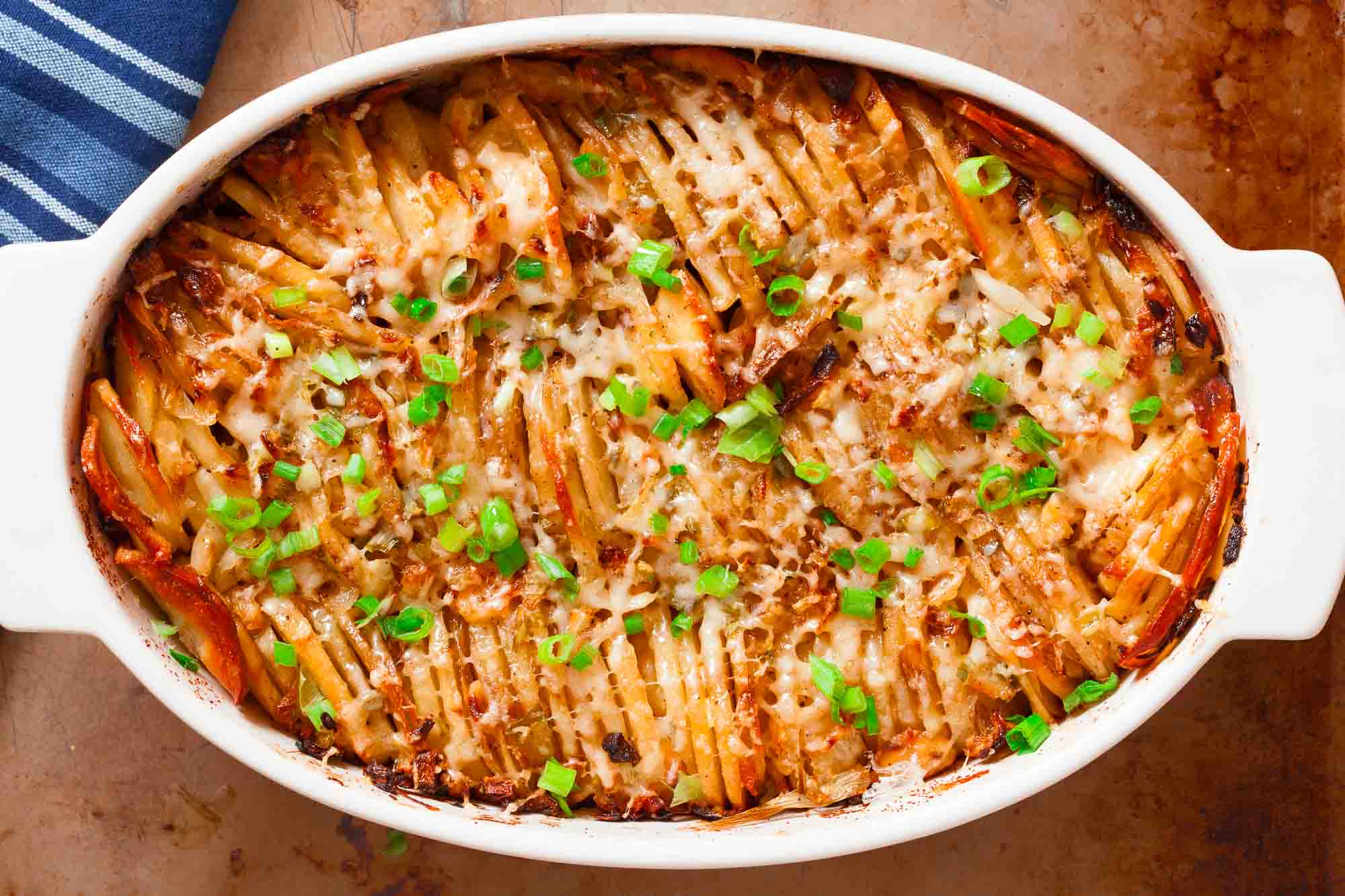 hasselback potato casserole in a white dish.