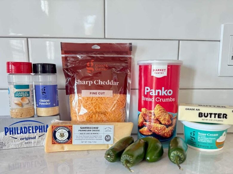 Ingredients to make jalapeno popper party dip on a white kitchen counter.