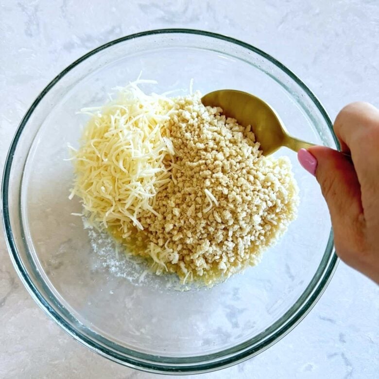 Jalapeño popper party dip topping ingredients in a bowl being mixed together.