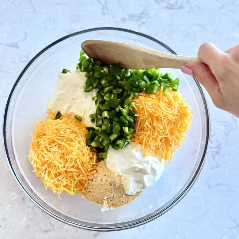 Jalapeño popper party dip ingredients in a bowl.