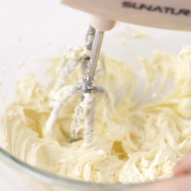Butter being creamed in a bowl to make levain chocolate chip cookies.