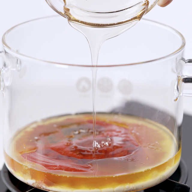 Buffalo chicken meatballs sauce being made in a pot.
