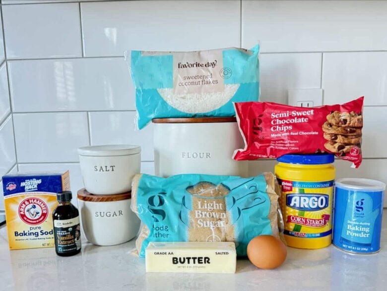 Ingredients to make coconut chocolate chip cookies on a white kitchen counter.