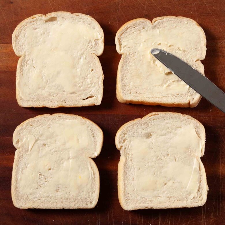 Cucumber sandwiches bread being buttered.