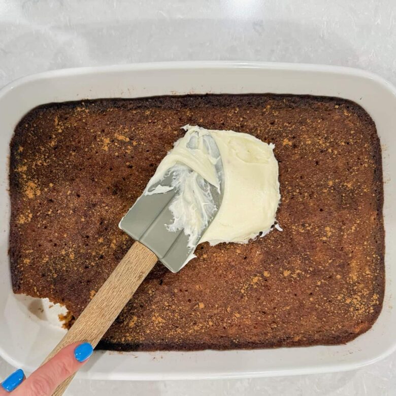 carrot cake being frosted.