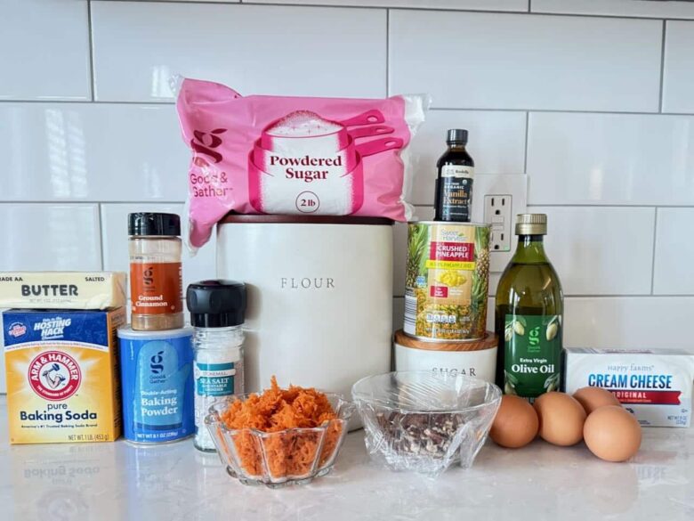 Carrot cake ingredients such as sugar, flour, oil, eggs, carrots, vanilla, cinnamon, and baking soda.