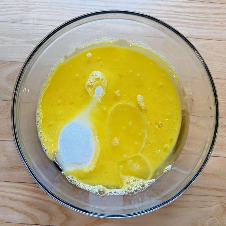 carrot cake wet ingredients such as eggs and oil in a bowl.