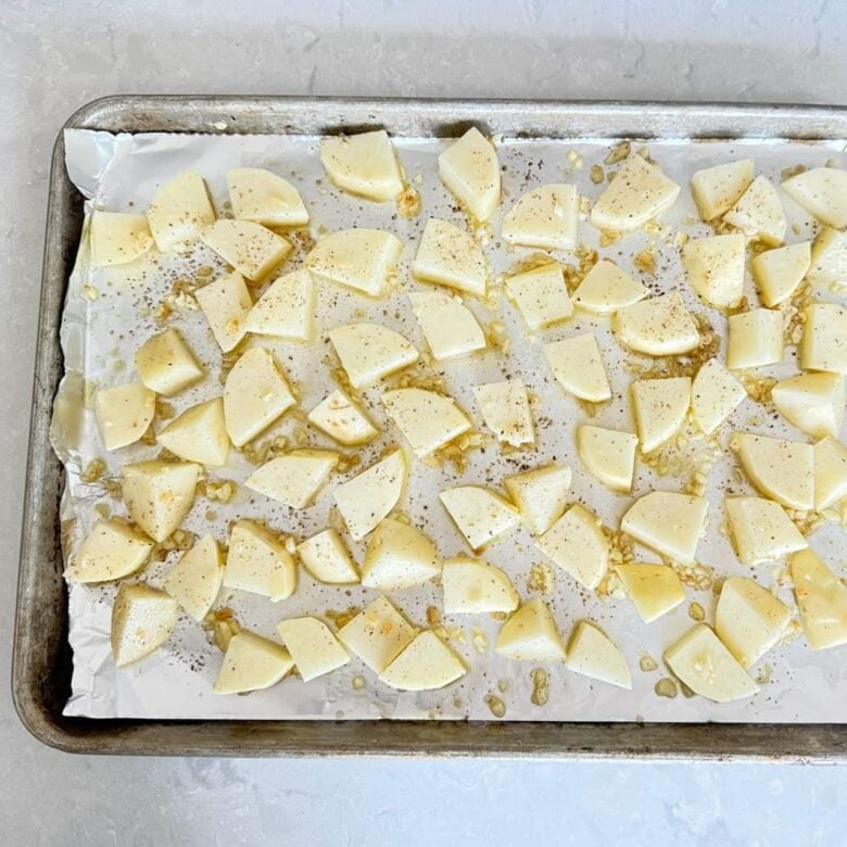 Greek lemon potatoes unbaked on pan.