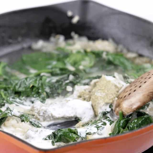 Pesto added to spinach mix to make chicken florentine pasta.