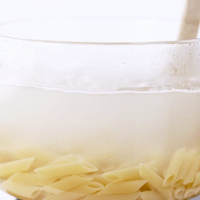 Pasta being boiled to make chicken florentine pasta.