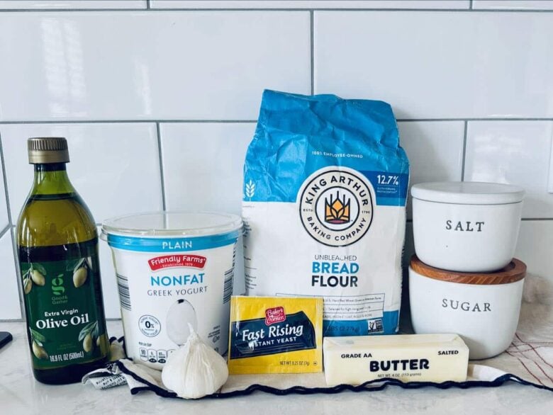Ingredients to make garlic naan on a kitchen counter.