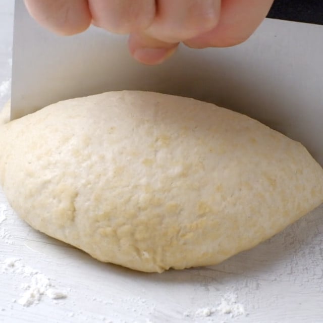 Garlic naan dough being divided.