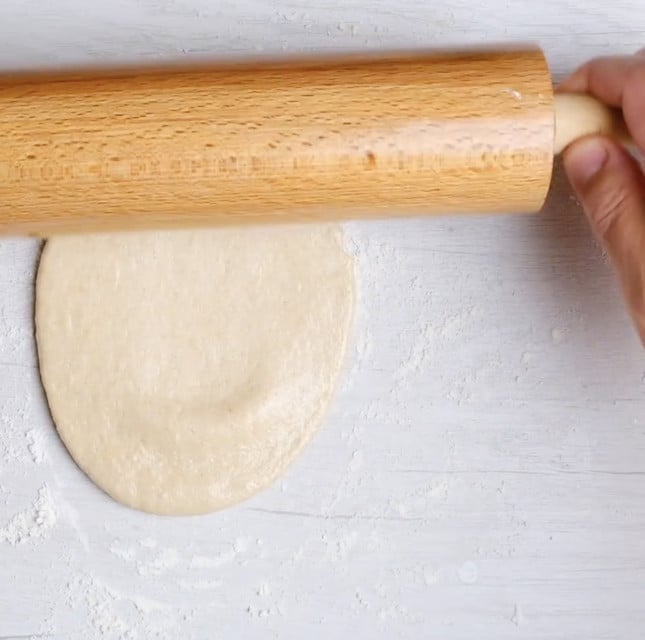 Garlic naan being rolled out.