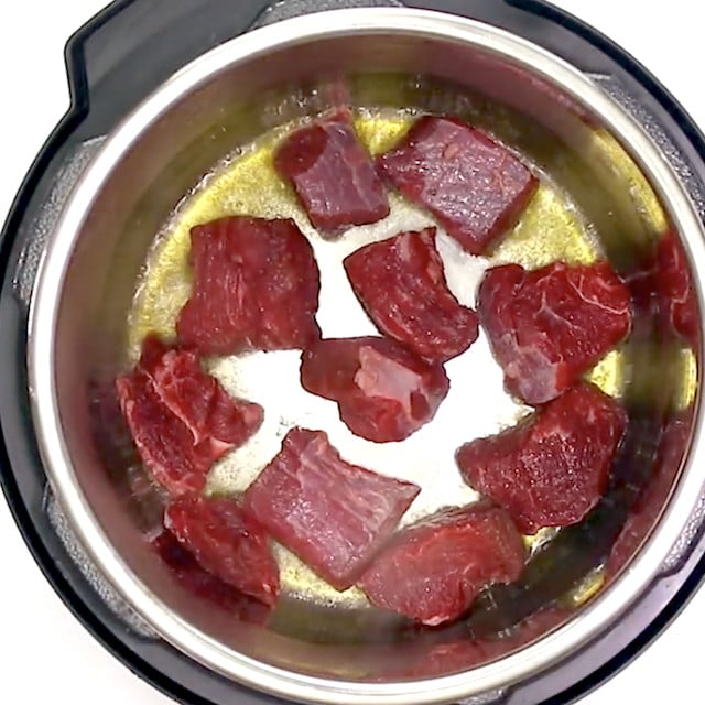 Chuck roast being sauteed in an instant pot.