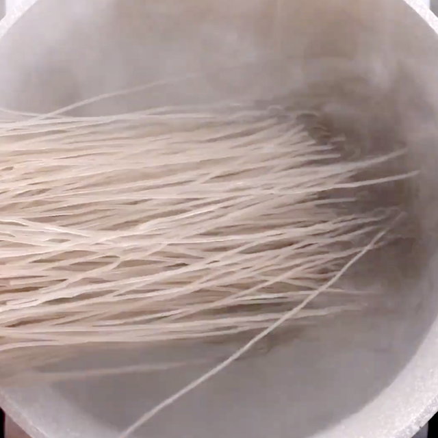 Noodles being boiled to make japchae at home.