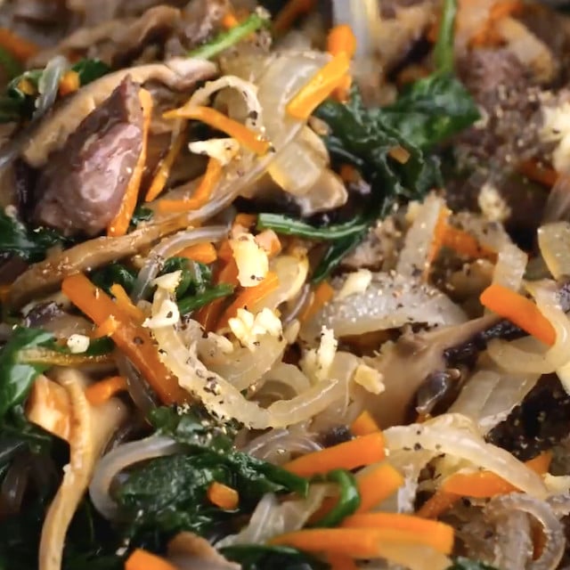 Japchae ready to be served after being tossed.