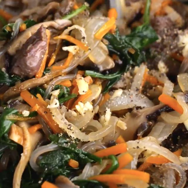 Japchae ready to be served after being tossed.