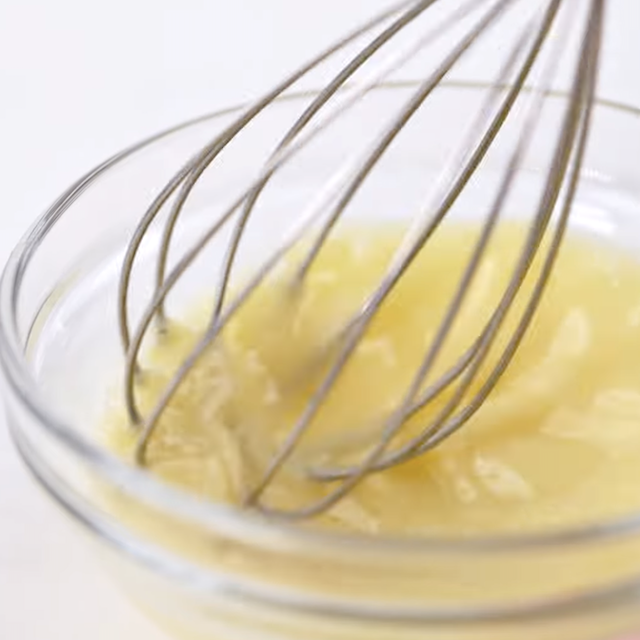 Egg yolks being tempered for lemon chicken soup.