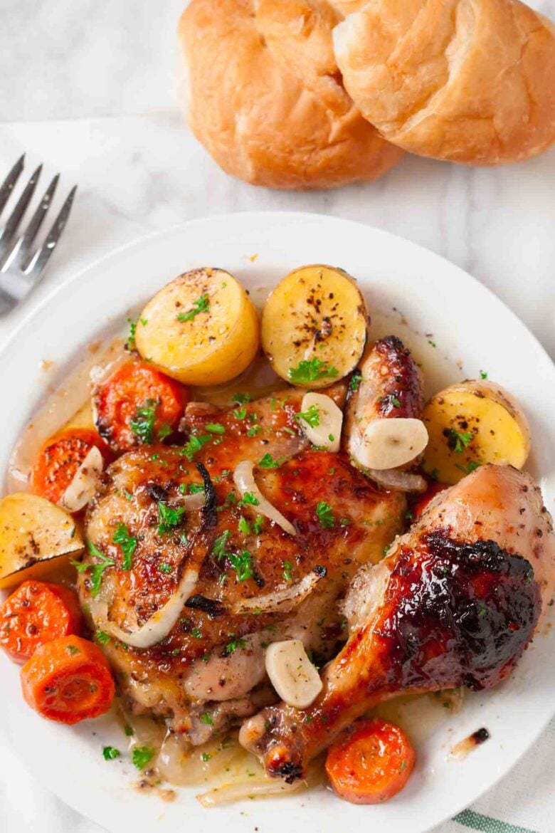 Overhead shot of sheet pan chicken and potatoes served in a plate.