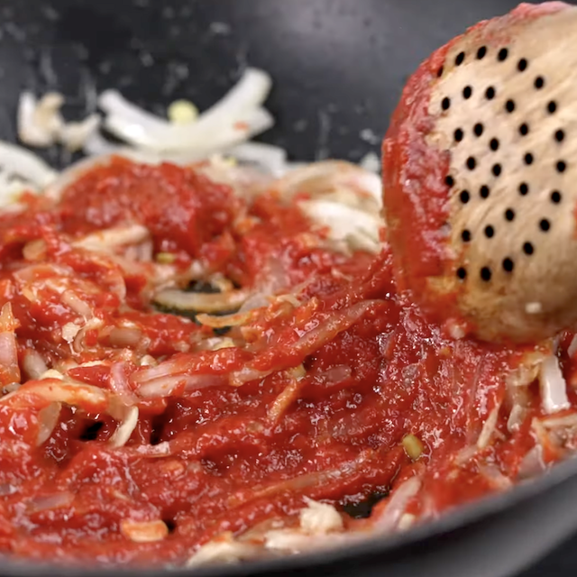 Curry paste being added to make thai curry noodles.
