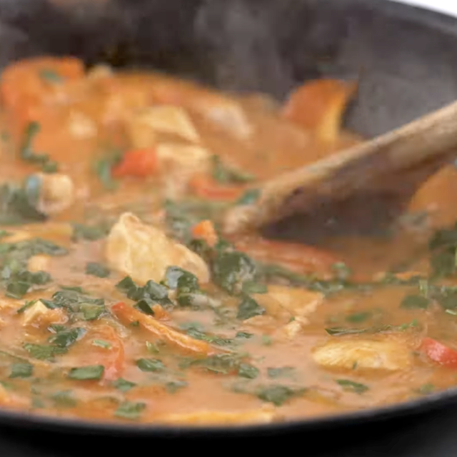 Thai curry being cooked to make Thai curry noodles.
