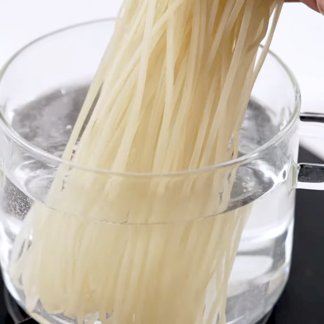 Noodles being boiled to make Thai curry noodles at home.