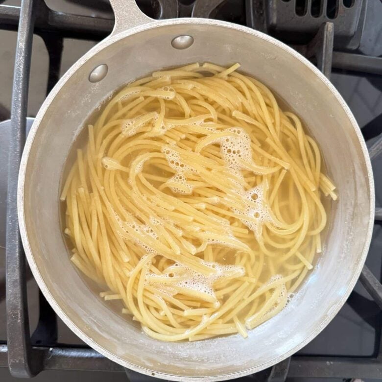 Avocado Pasta Noodles cooking in a pot on the stovetop. 