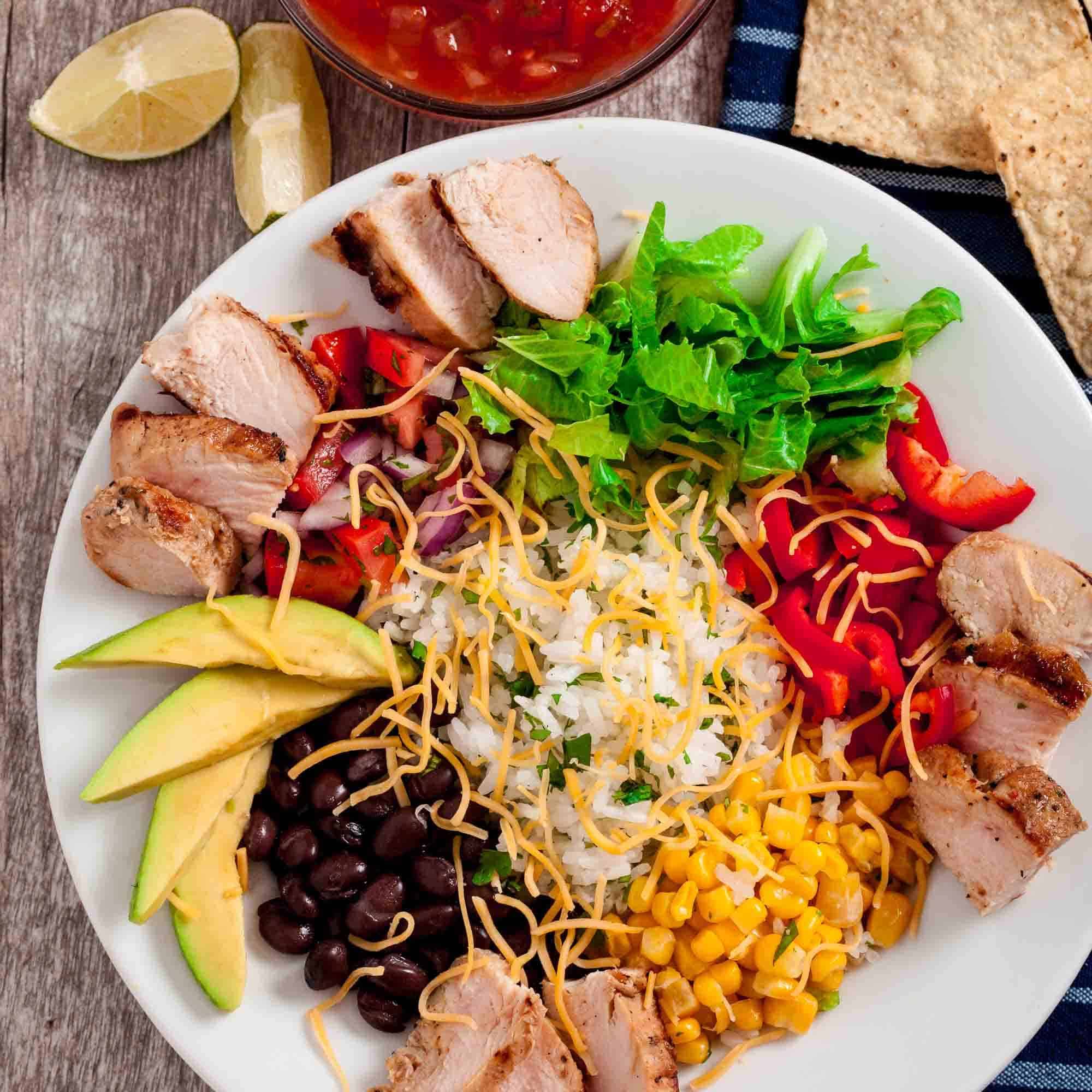 Overhead shot of chipotle chicken burrito bowls, ready to be served.