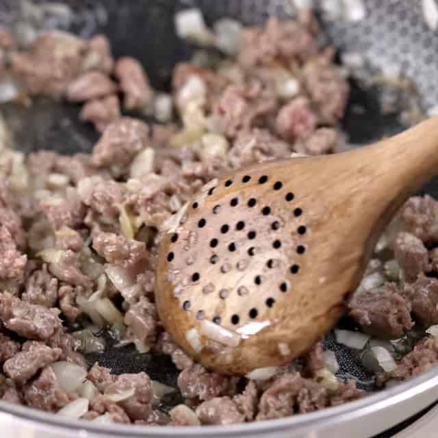 Ground sausage being cooked to make gnocchi with sausage.