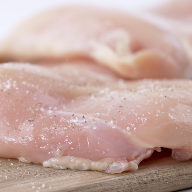Chicken being seasoned to make lemon chicken pasta.