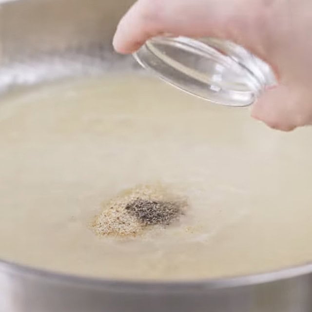 Seasonings being added to make lemon chicken pasta at home.