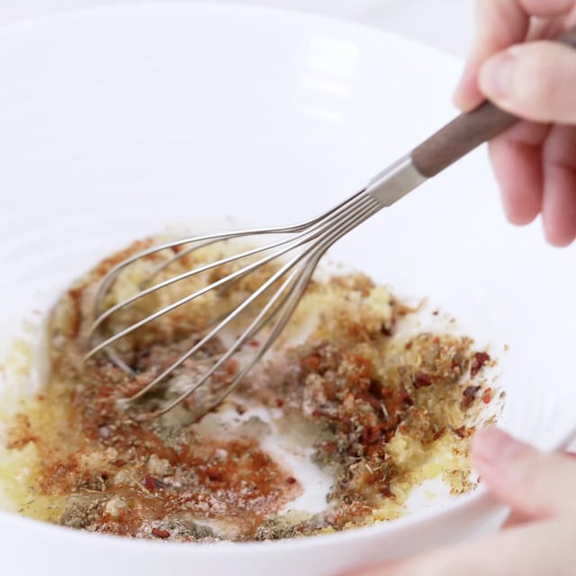 Lemon garlic chicken marinade in a glass bowl.