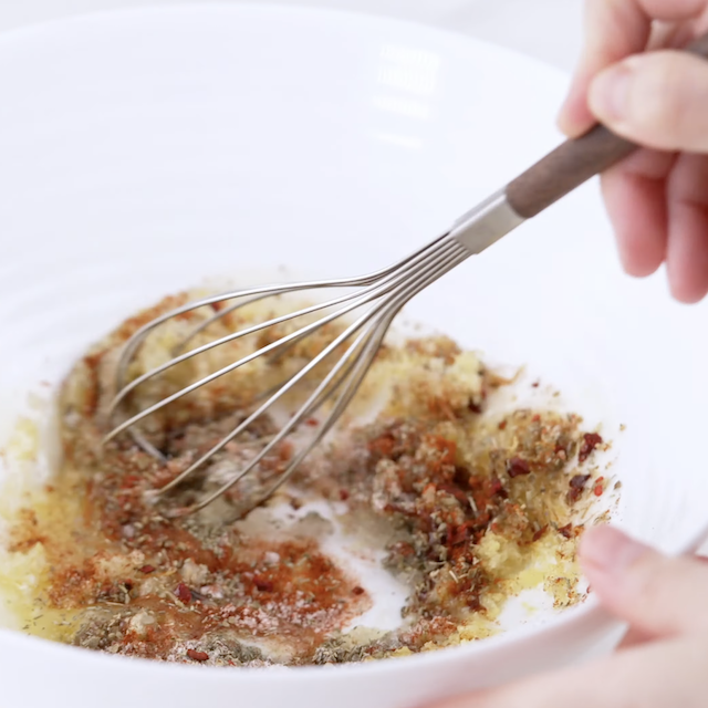 Lemon garlic chicken marinade in a glass bowl.