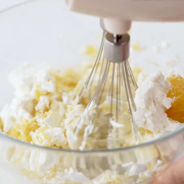 Cream cheese being beaten with lemon curd to make blueberry french toast casserole.