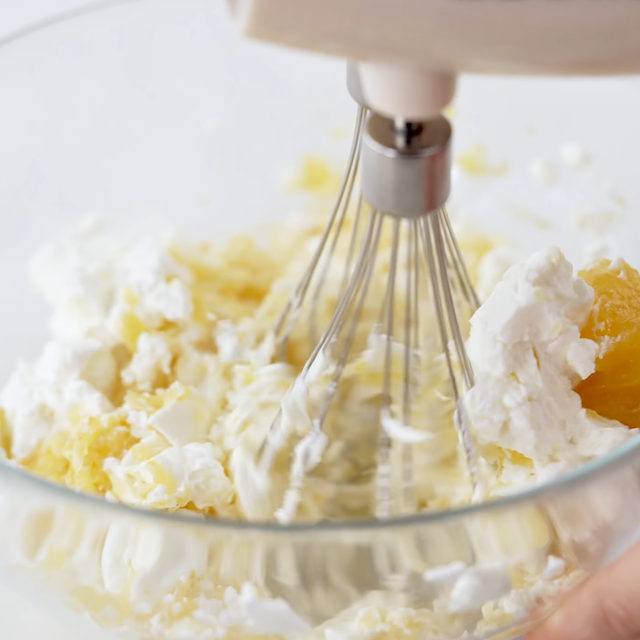 Cream cheese being beaten with lemon curd to make blueberry french toast casserole.